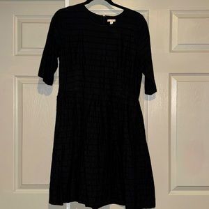 Blqck eyelet dress, full skirt, 3/4 length sleeves.